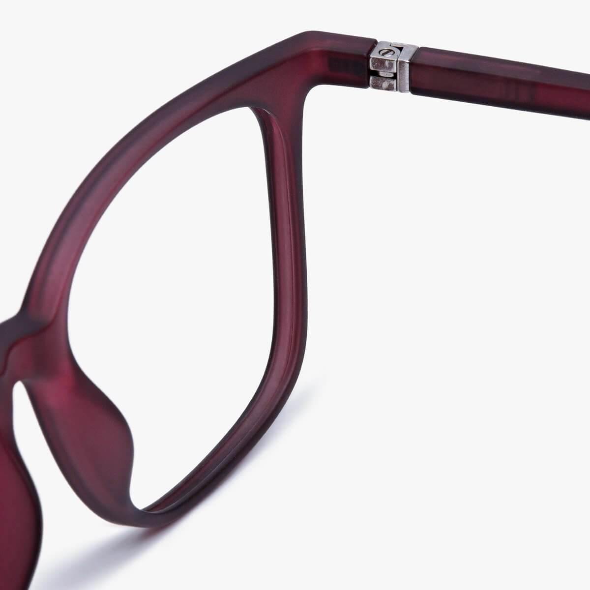 Close-up of Fyn Red eyeglasses with a matte red frame and silver hinge