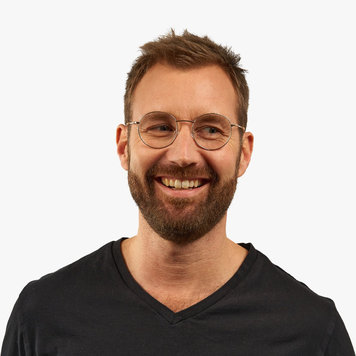 Person wearing round gold reading glasses