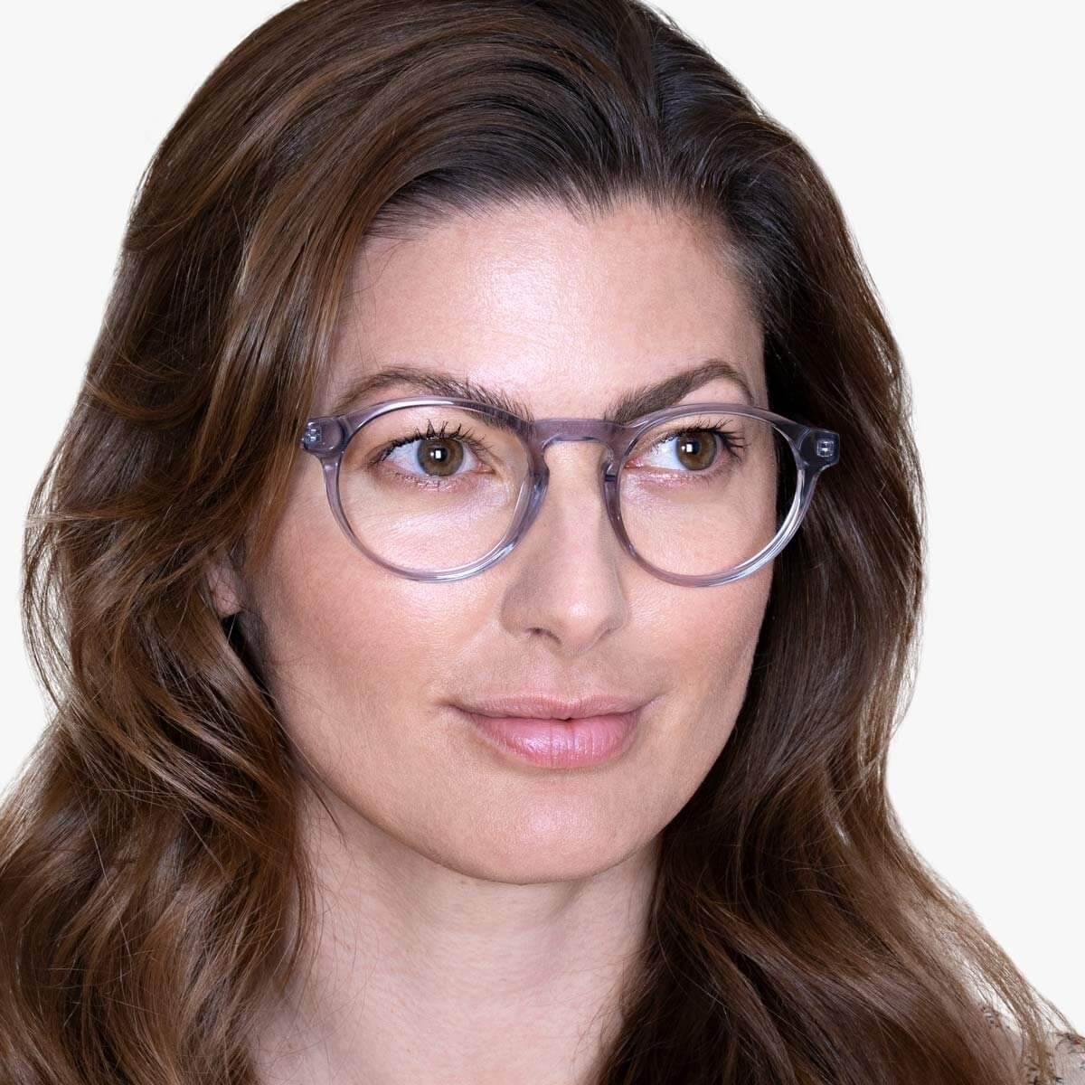 Person wearing Trondheim Crystal Grey reading glasses