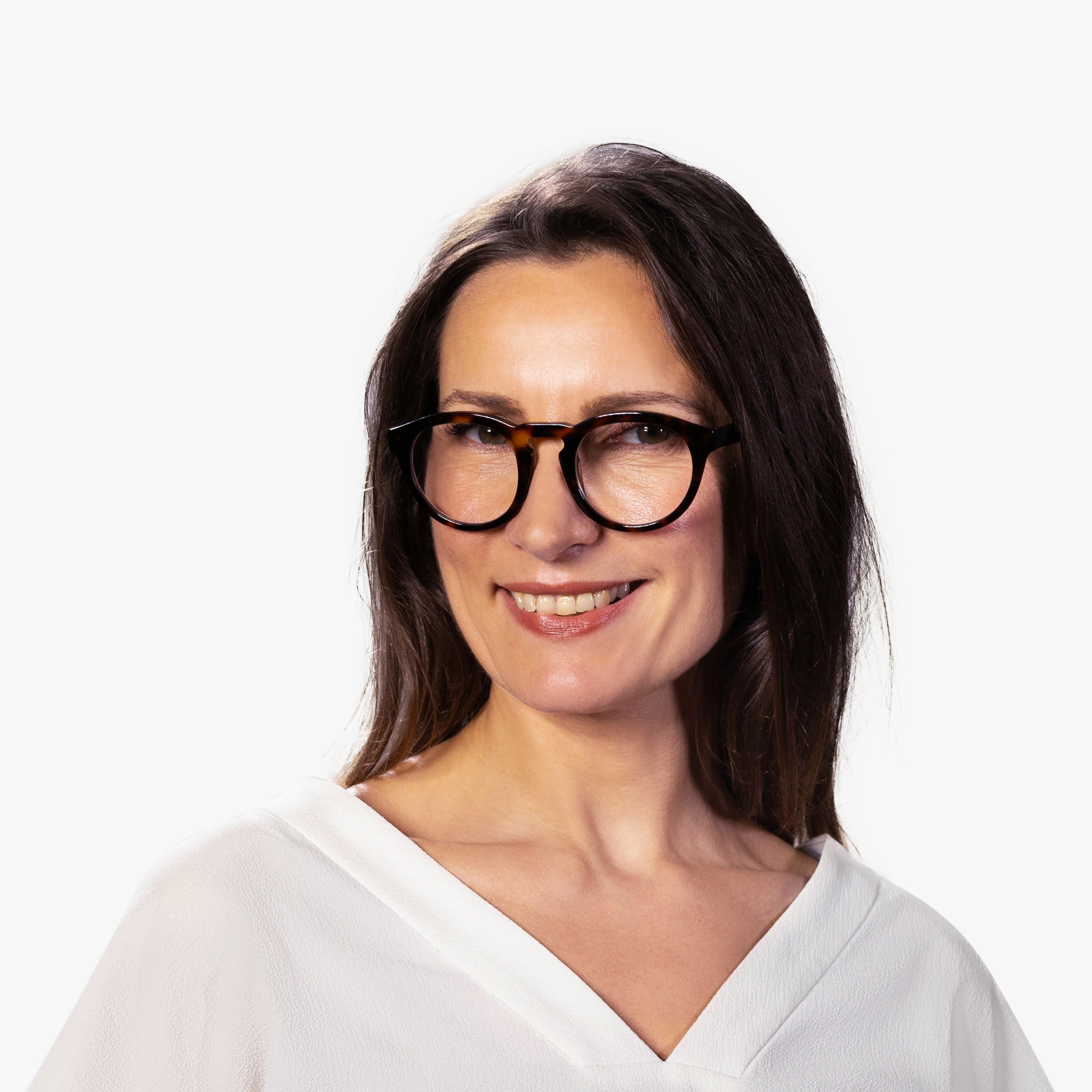 Person wearing tortoise shell round reading glasses