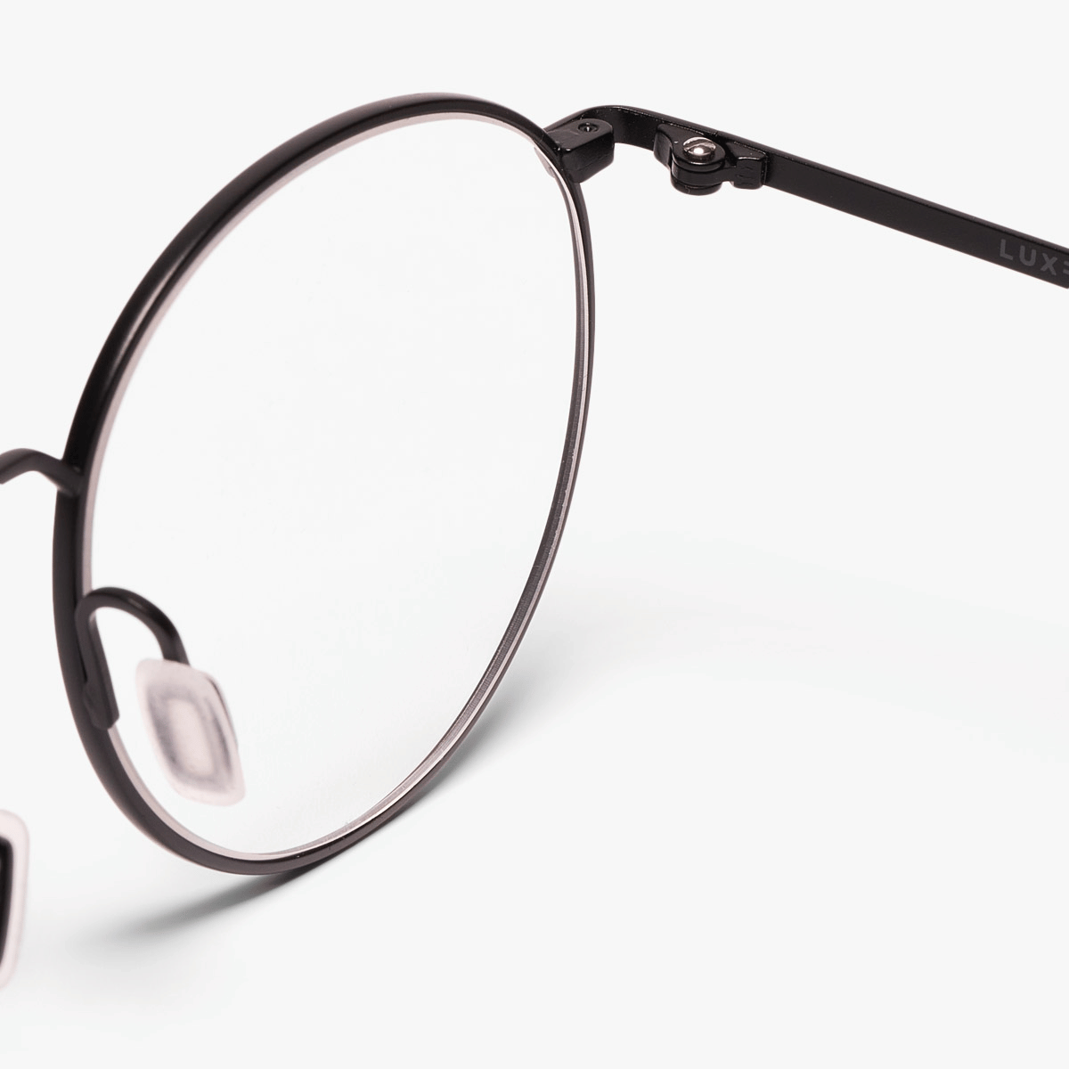Close-up of black round glasses frame with Luxreaders branding