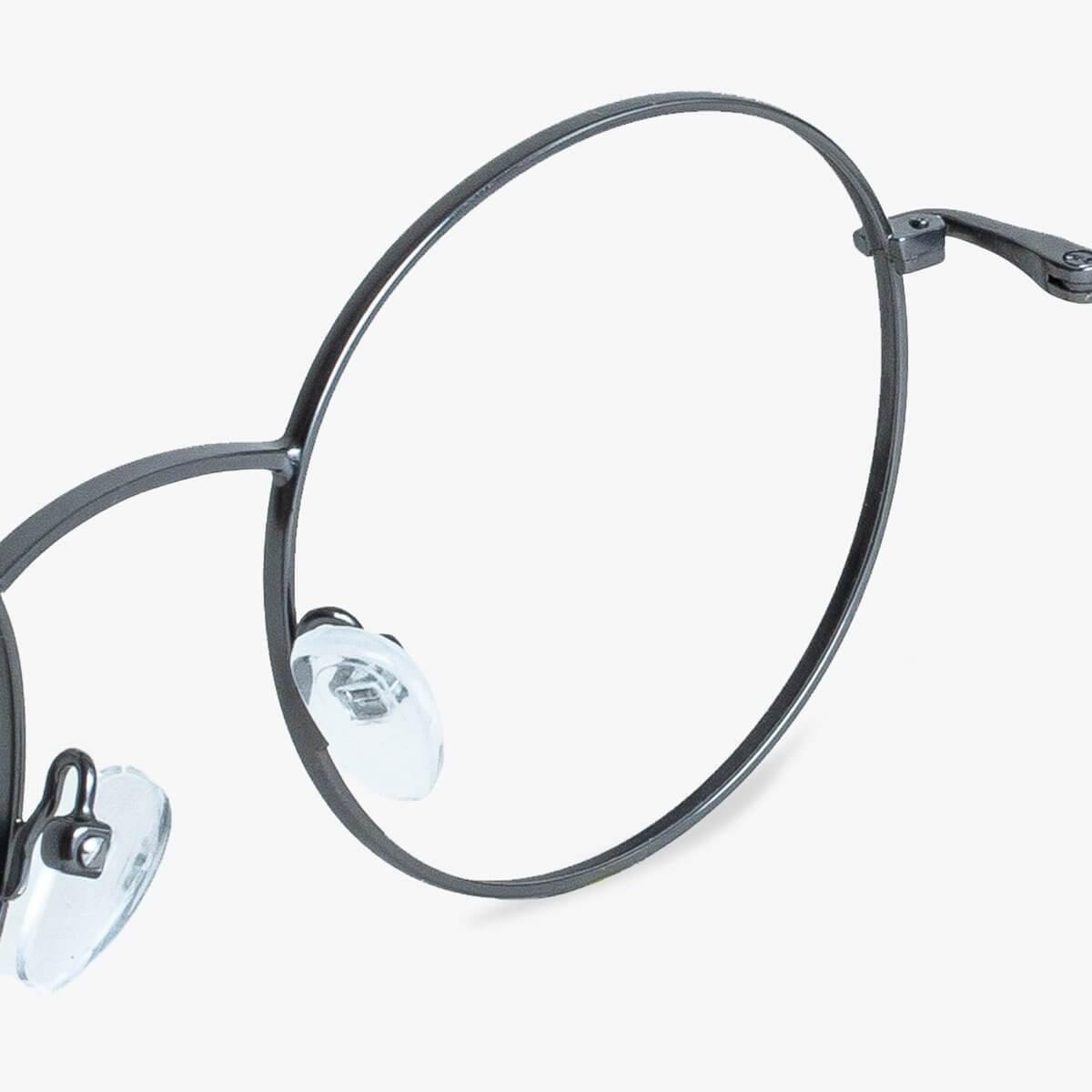 Close-up of round metal glasses with clear nose pads